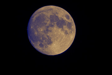 Telescope view of the full moon in the night sky