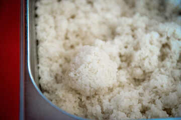 Portion of boiled rice in the form of a ball for making sushi, close-up.