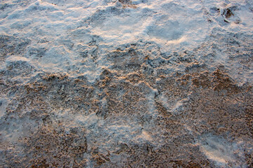 Salty sea shore.Texture of sea salt farm is the place with so much sea-salt production in the country,or salt evaporation plant these ponds have vivid colors.
