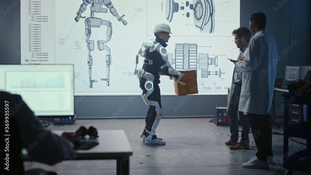 Aufkleber In Development Laboratory: Engineers Look at Robotics Exoskeleton Prototype Presentation with Person Testing it, Lifting Heavy Carboard Box. Designing Wearable Exosuit to Help Warehouse Workers