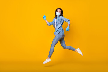 Full length body size profile side view of her she nice attractive active healthy slim girl wearing safety mask jumping running stop flu isolated bright vivid shine vibrant yellow color background