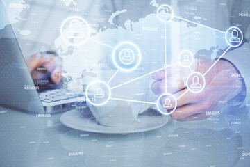 Social network theme hologram with businessman working on computer on background. Multi exposure.