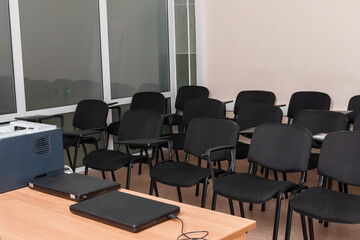 A row of black chairs  in a conference room for training. The concept of empty classes because of the coronavirus epidemic.