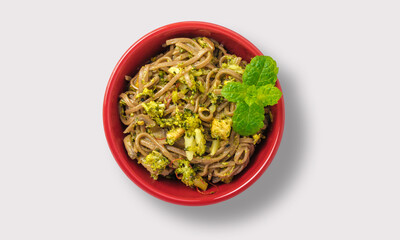 Noodles in a red bowl on a white background