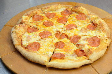 Pizza cut into pieces on the kitchen table.