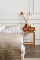 Cozy details in white contemporary bedroom interior with gypsum stucco on white walls © vladdeep