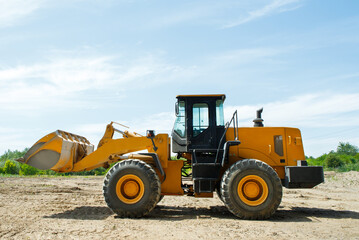 Obraz na płótnie Canvas Wheel loader excavator at construction site