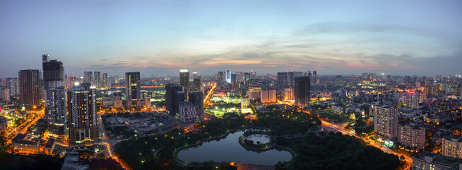 Fototapeta premium Cityscape of Hanoi skyline at Cau Giay park during sunset time in Hanoi city, Vietnam