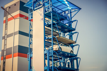 Vertical automated car Parking system on the street. Automatic multi-storey automated Parking systems stand on a Sunny day.
