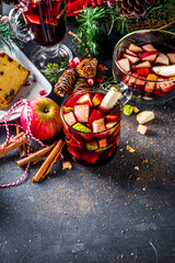 Festive winter fruit punch or sangria drink. Christmas mulled red wine. Ponche de frutas Navideño cocktail, Mexian Christmas hot  beverage with sugar cane and fruit, hot sweet liquor wine drink