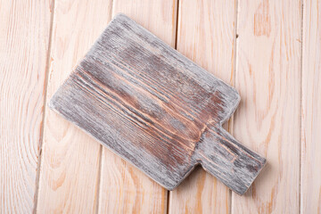 Fototapeta na wymiar Handcraft white wooden old cutting board, grey background, angle view