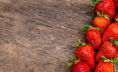Tasty strawberry on a wooden table. It can be used as a background