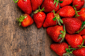 Ripe strawberries on wooden table. Fresh strawberries on wooden background