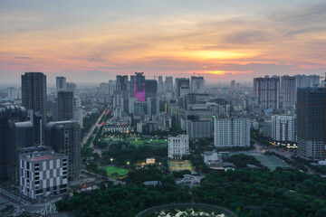 Fototapeta na wymiar Cityscape of Hanoi skyline in Cau Giay district by Cau Giay park during sunset time in Hanoi city, Vietnam
