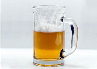 Glass mug of beer with foam