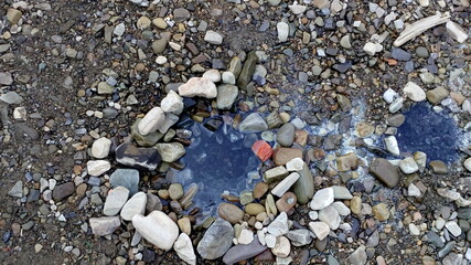 Natural source of water with sulfur among the stones.