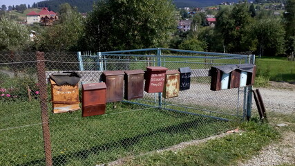 Old mailboxes on the fence in the village. Retro mail.