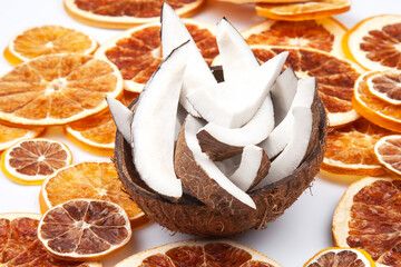 coconut with nut chips on a background of dried citrus fruits