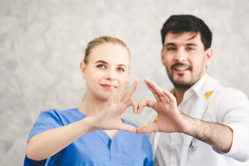 Medical doctor and surgeon making hand on heart shape