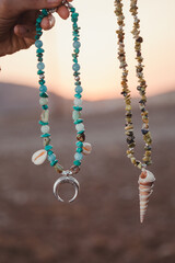 a Necklace in a desert place background in the sunset time  of a day of summer in the south of Europe
