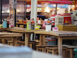 wooden tables and chairs but no people lonely in food shop, greasy spoon, hash house