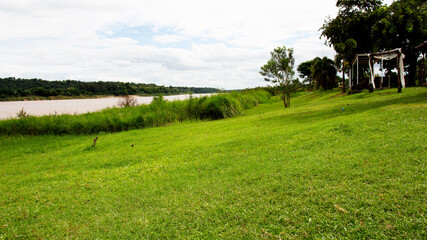 Obraz premium green park beside the river and the beautiful sky