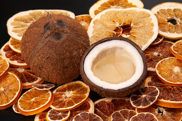 coconut with natural milk on a background of dried citrus fruits