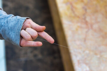 The boy shoots a web out of his hand like a spider. A person plays the hero of a movie, a comic...