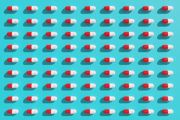 Red and white pills pattern on a light blue background. 3d illustration.