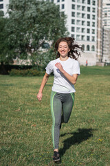 Beautiful woman running in city park