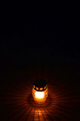 Votive candle on dark background. All Saints Day candle