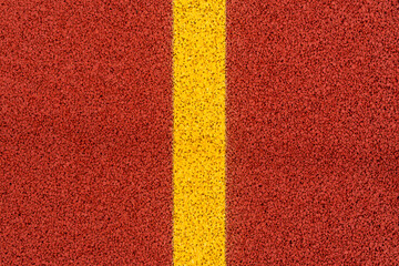 Yellow line on red stadium running track