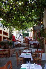 Fototapeta na wymiar Narrow streets in Athens where to eat or drink something