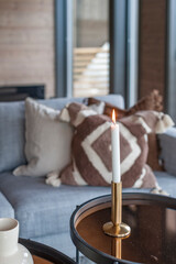 Small coffee tables with a a coffee cup and a candle. Beautiful Scandinavian design.