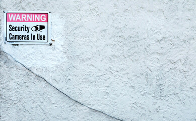 Security Sign on White Building
