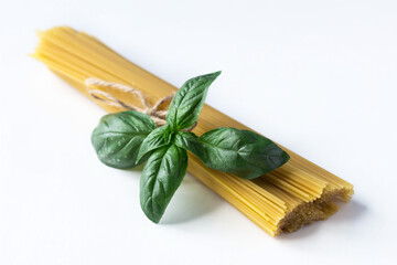 raw spaghetti lie on a white table