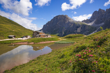 Fototapeta na wymiar Dolomites landscape near Passo Rosse with little lake in Trentino, Italy