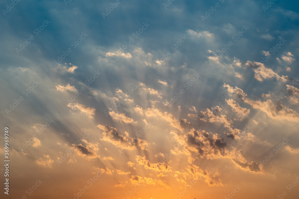 Wall mural Sun beams breaking through clouds