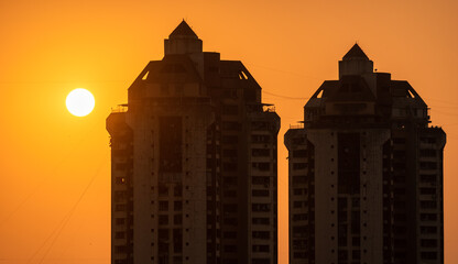 Sun sets behind skyscrapers in Mumbai