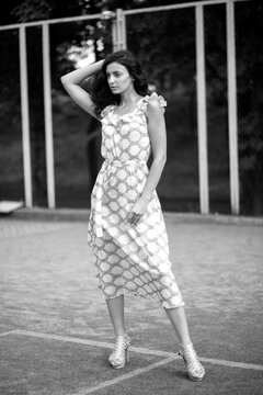 Fototapeta Fashionably dressed woman on the streets of a small Italian town