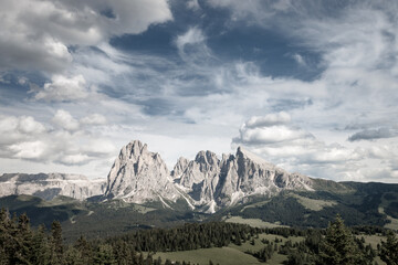 Alpe di Siusi - Seiser Alm with Sassolungo - Langkofel mountain group in front of blue sky with clouds