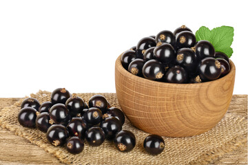 black currant in the bowl on wooden table isolated on white background with clipping path and full depth of field