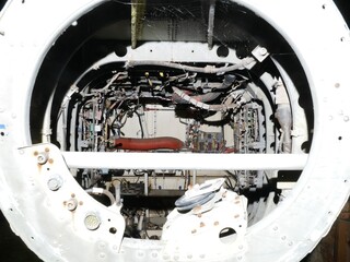 inside tail of disused abandoned Helicopter grounded at night with daylight lighting to show controls wiring and component parts 