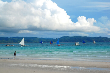Fototapeta na wymiar Beach shore and sail boats at Boracay Island in Aklan, Philippines