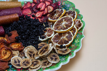 dried fruits on a plate with lemon and banana and strawberry