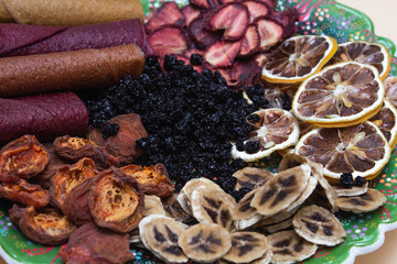 dried fruits on a plate with lemon and banana and strawberry