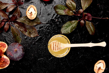 Autumn frame background. Autumn food still life with season fruits grape and figs, honey on a black table. Thanksgiving day.