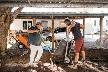 2 men constructing a fence