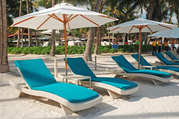 Hennan resort beach chairs in Alona beach, Panglao island, Bohol, Philippines.