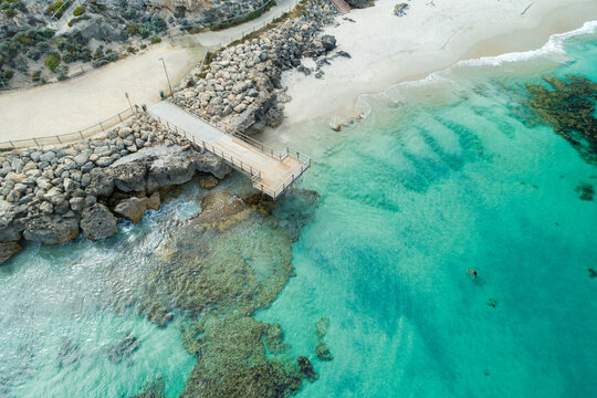 aerial view of wooden pier on beach